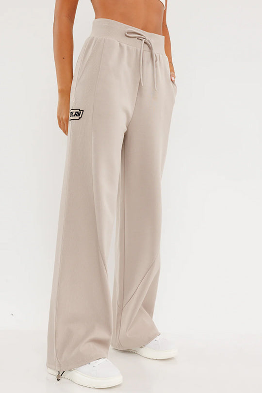 מכנסיים ארוכים לנשים בצבע בז' עם לוגו
